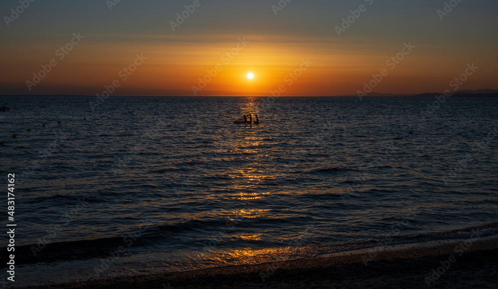 Obraz premium Tranquil scene of beautiful sea at sunset. Orange and yellow sunset on the sea. Aerial panoramic view of sunset over sea.
