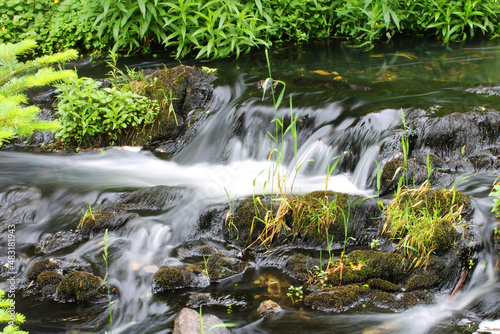 Fototapeta Naklejka Na Ścianę i Meble -  Close-up of a small waterfall on a river