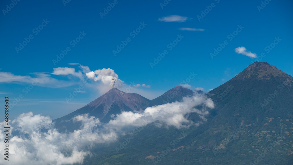 Panoramic view of Fuego volcano eruption, molten rocks, hot ash, gas and smoke belched up from the crater during explosion. Acatenango volcano trek. Natural disaster in Guatemala, Central America.