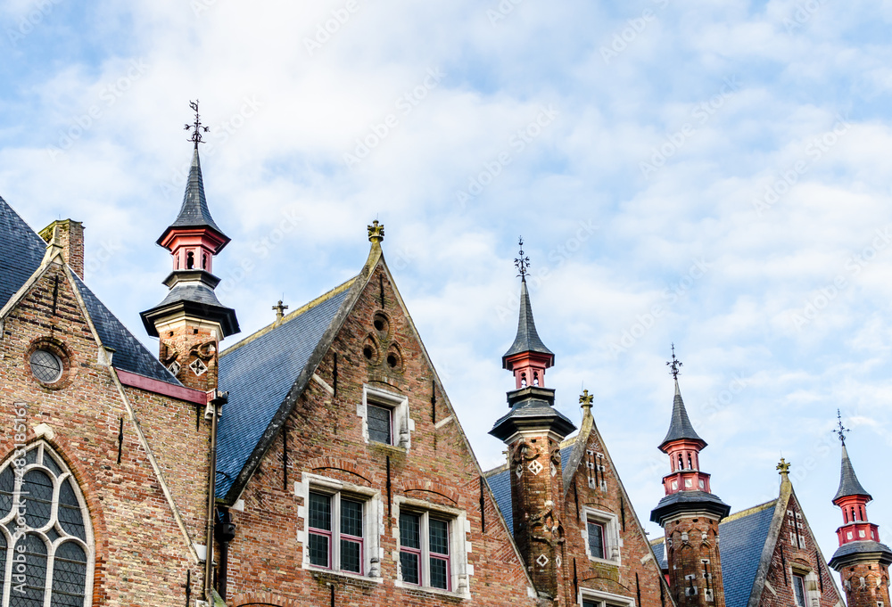 Fototapeta premium Bruges, Belgium; view of the medieval buildings that are crossed by the canals of the city. Historic center World Heritage