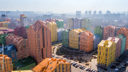 Canvas Print aerial view of colorful (red, green, blue, yellow) buildings on city street
