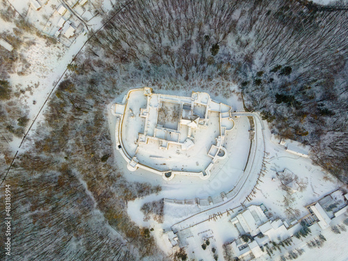 Birds eye view over the medieval stronghold of Suceava. Aerial photography of the medieval fortress from Suceava, Romania shot from a drone in winter season.  photo