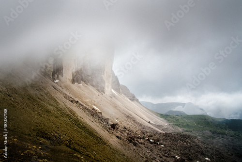 Peaks of Tre Cime di Lavaredo covered by stormy clouds after a break in the weather, Dolomites, Italy