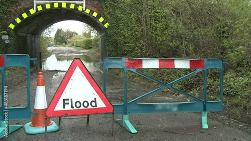Floods in May 2012 Southern UK with sign and railway bridge