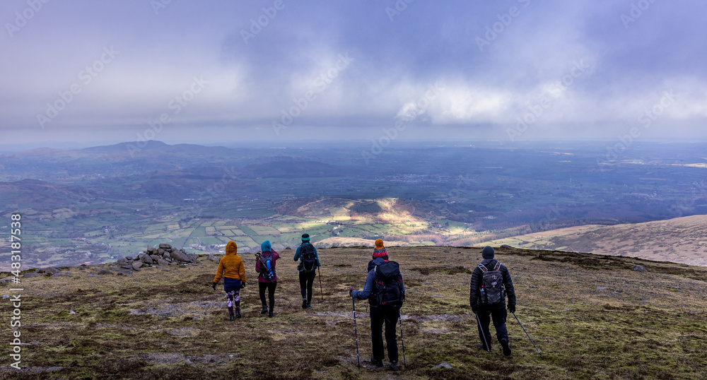 Hikers on Slieve Meelmore in the Mourne Mountains, Area of outstanding natural beauty, County Down, Northern Ireland