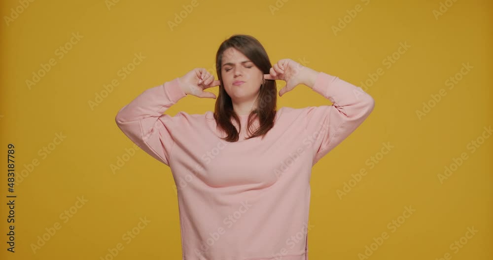 Stubborn annoyed young girl plugging with fingers covering ears ignoring, refuse to listening, grimacing. I don't hear Stubborn annoyed young girl plugging with fingers covering ears ignoring, refuse to listening, grimacing. I don't hear