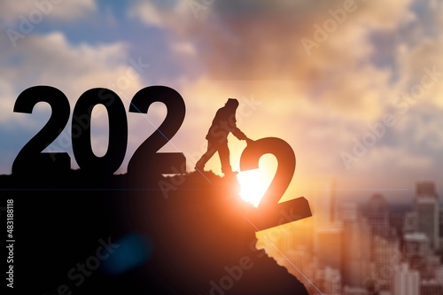 2022 New Year concept. People who lift the numbers.