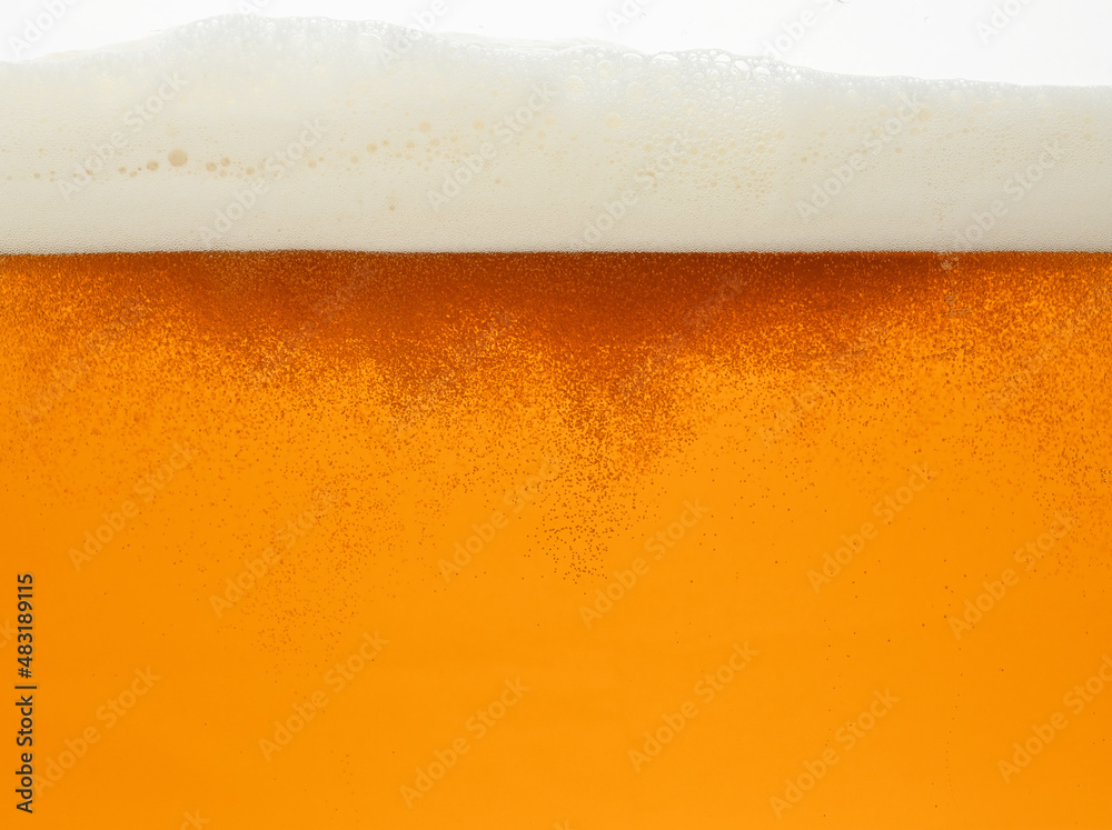 Close up background of beer with bubbles in glass Close up background of beer with bubbles in glass