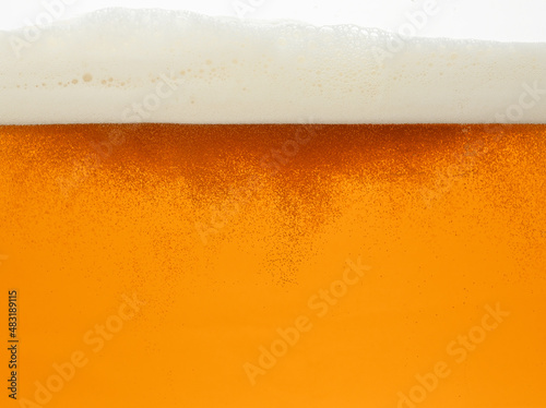 Close up background of beer with bubbles in glass