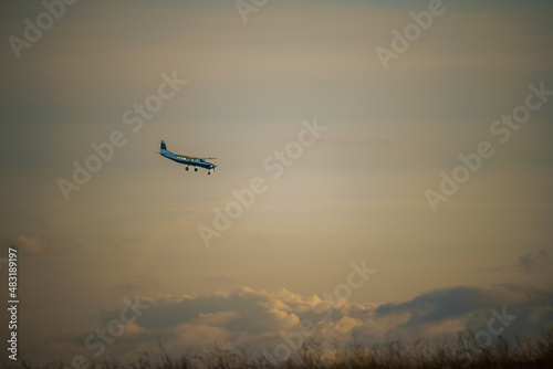 Cessna 208b Grand Caravan G-CPSS light aircraft returning to land, moody sunset sky