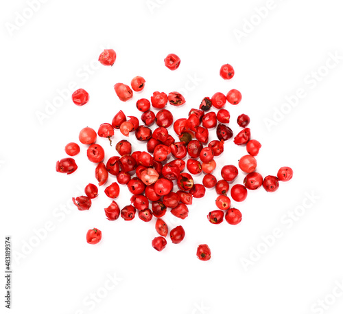 Heap of red pink peppercorns isolated