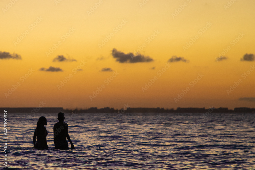 Pareja de novios disfrutando del 14 de febrero en playas de Isla Mujeres al atardecer. 