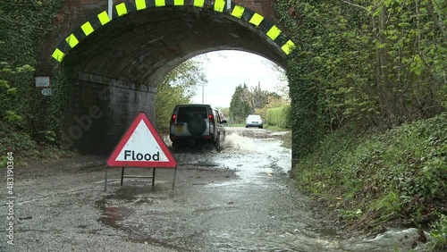 Floods in May 2012 Southern UK with sign and railway bridge