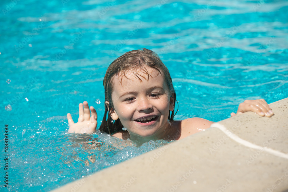Portrait of kid in swimming pool. Cute boy in the water playing with water.