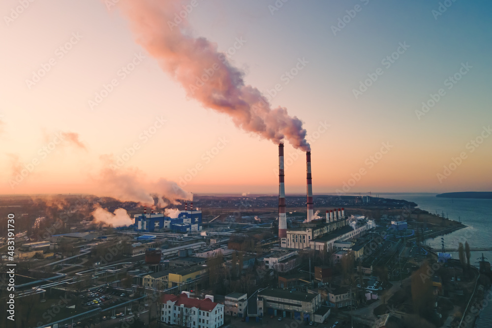 Air pollution by smoke of the factory smokestack in the industrial zone. Industrial plant pipe and Global warming concept