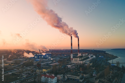 Air pollution by smoke of the factory smokestack in the industrial zone. Industrial plant pipe and Global warming concept