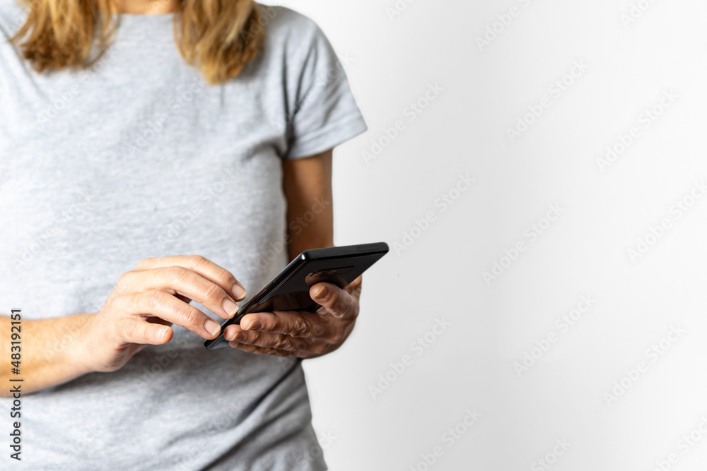 Female hands using a smartphone, close-up. Female hands using a smartphone, close-up.