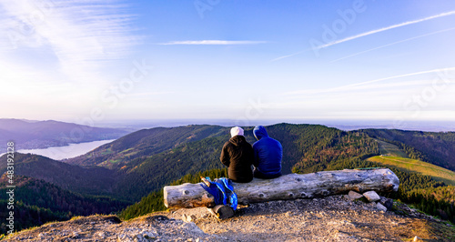 Man and woman taking a break on the summit in the Alps