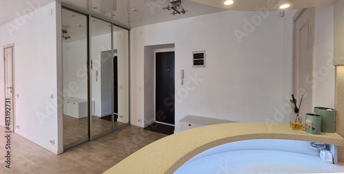 Fotografie interior of a bright hallway with a mirrored wardrobe compartment