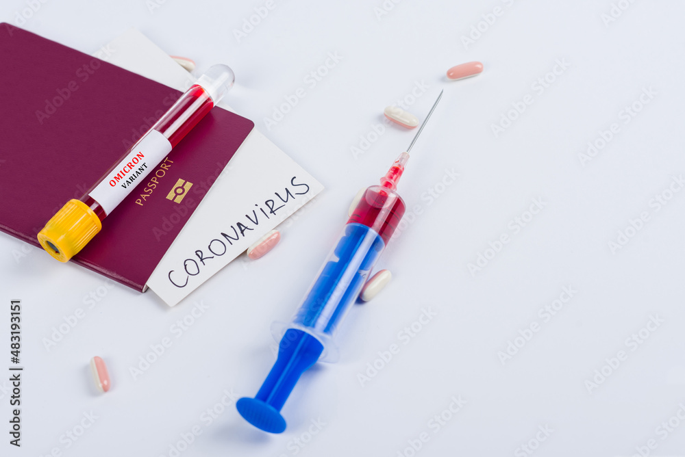 Passport and test tube with a positive blood test for Omicron. Pills and syringe with blood for coronavirus analysis (COVID-19) Passport and test tube with a positive blood test for Omicron. Pills and syringe with blood for coronavirus analysis (COVID-19)
