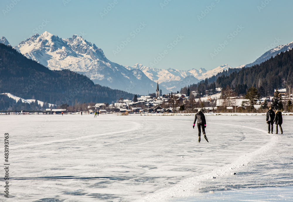 skaters on a frozen lake at the White lake (in German Weissensee)