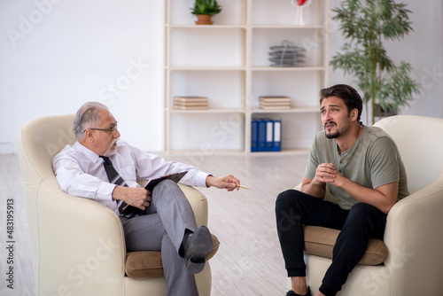 Young man visiting old psychologist © Elnur