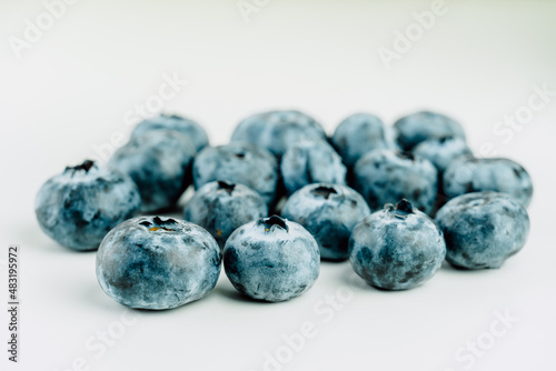 Close up view of group of fresh blueberries on a white background.