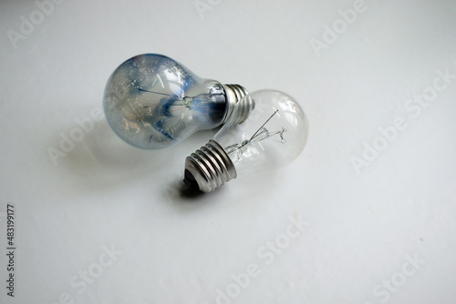 burned out and new light bulb on a white background, close-up