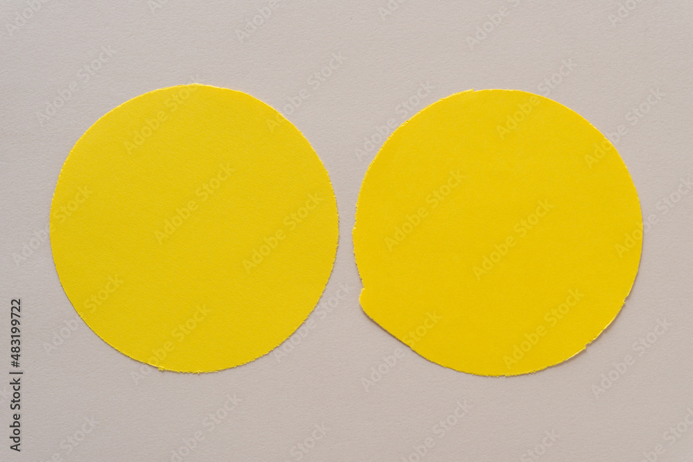 two yellow circles on beige paper two yellow circles on beige paper