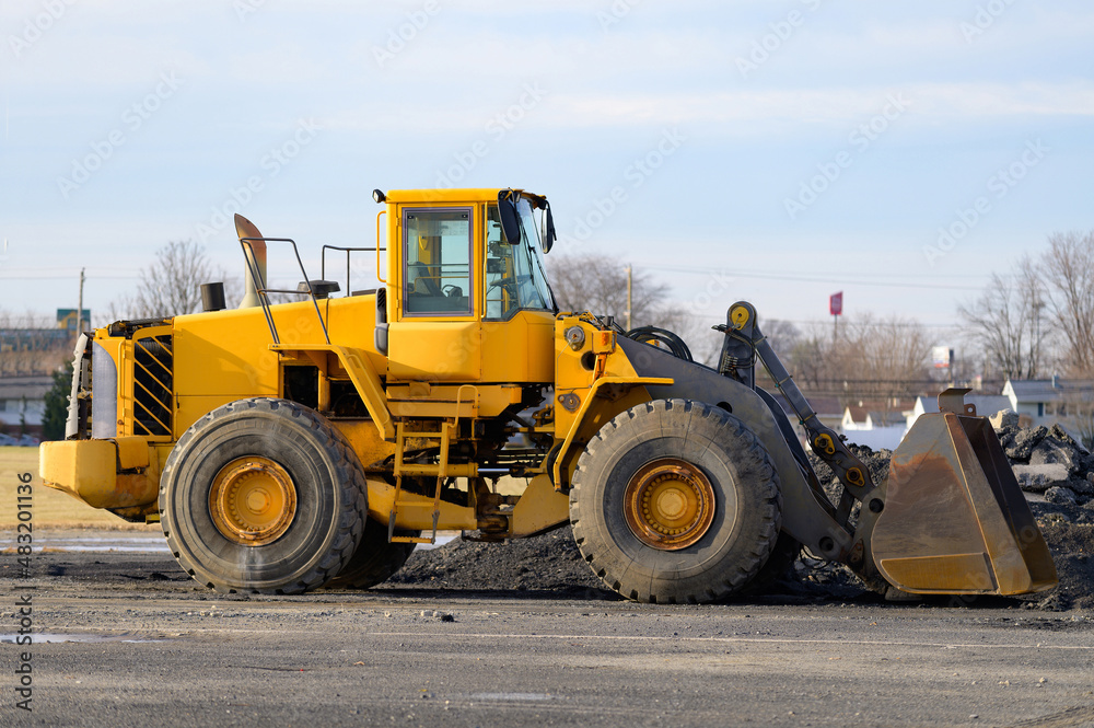 Big excavator on new construction site yellow