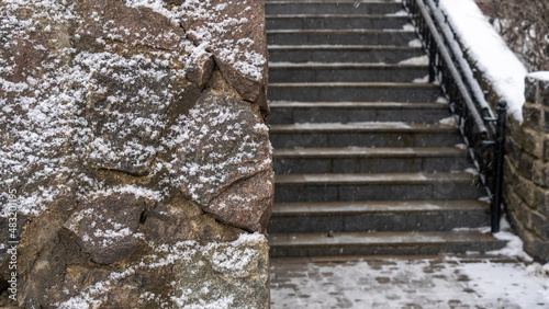 Old stone wall in winter weather. In the background staircase. Moody concepts. Textured and background. Selective focus.