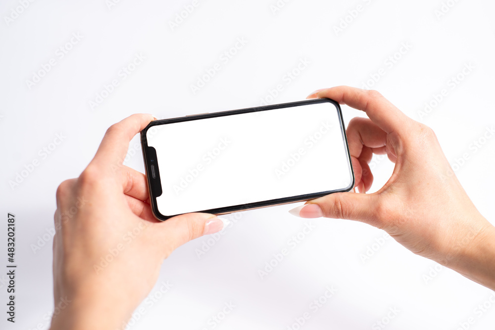 Mobile phone with blank white screen held in two hands on white background Mobile phone with blank white screen held in two hands on white background