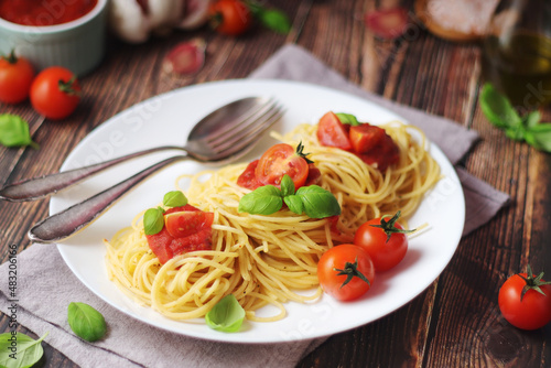 Italian pasta spaghetti with basil and cherry tomatoes 