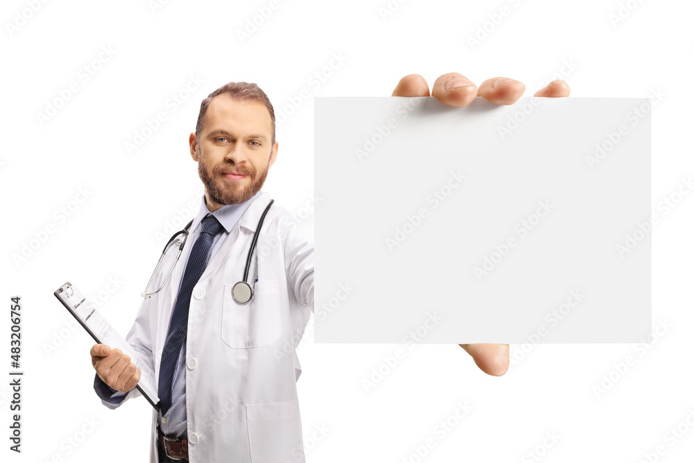 Young male doctor holding a blank cardboard in front of camera Young male doctor holding a blank cardboard in front of camera
