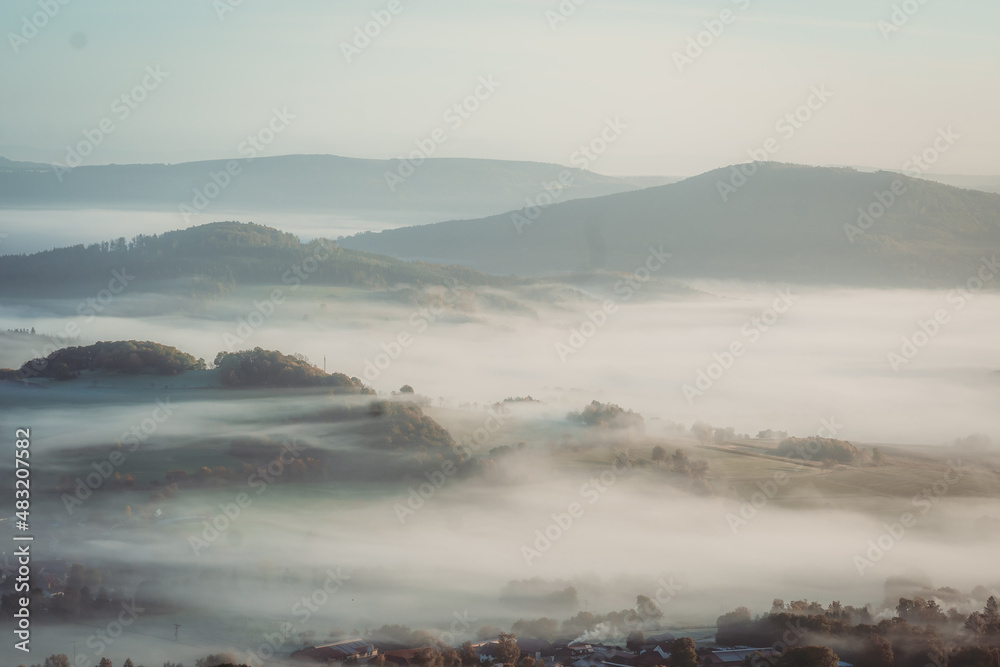 Natural Foggy European Landscape during morning Sunrise with Hills and valleys