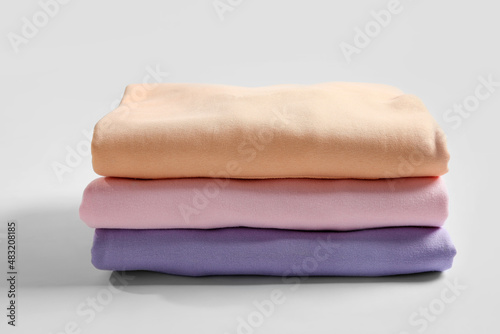 Stack of colorful clothes on white background