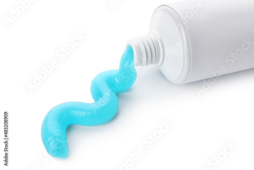 Tube with squeezed toothpaste on white background, closeup photo