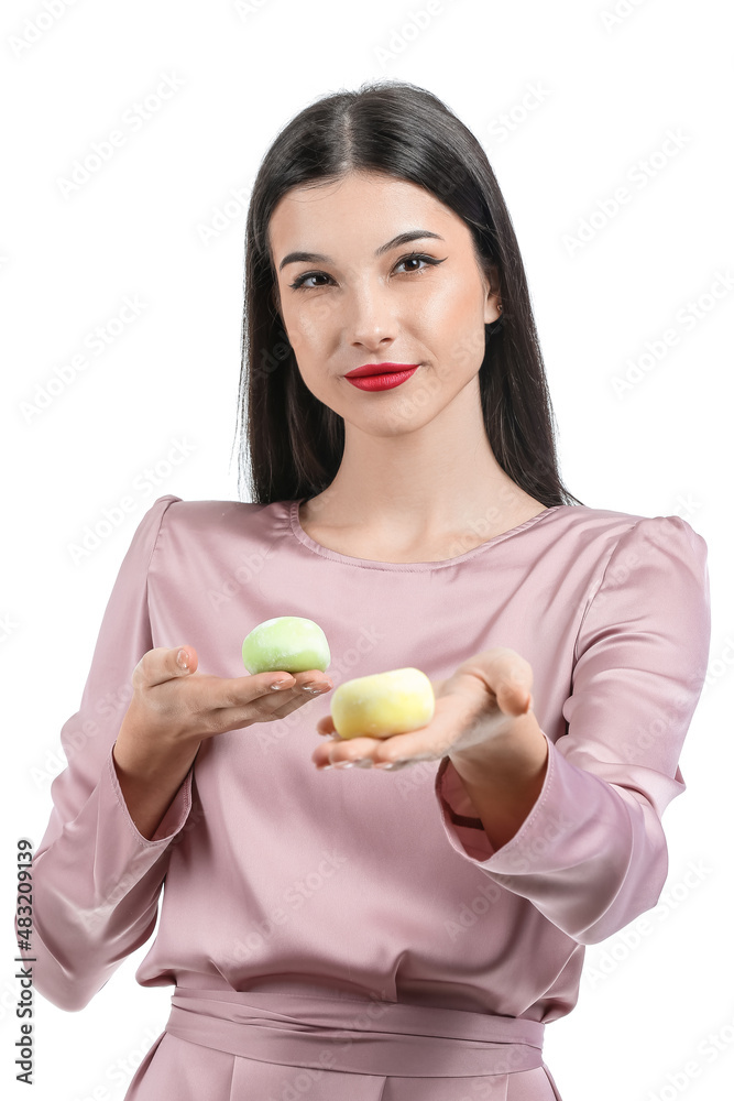 Beautiful young woman with tasty Japanese mochi isolated on white Beautiful young woman with tasty Japanese mochi isolated on white