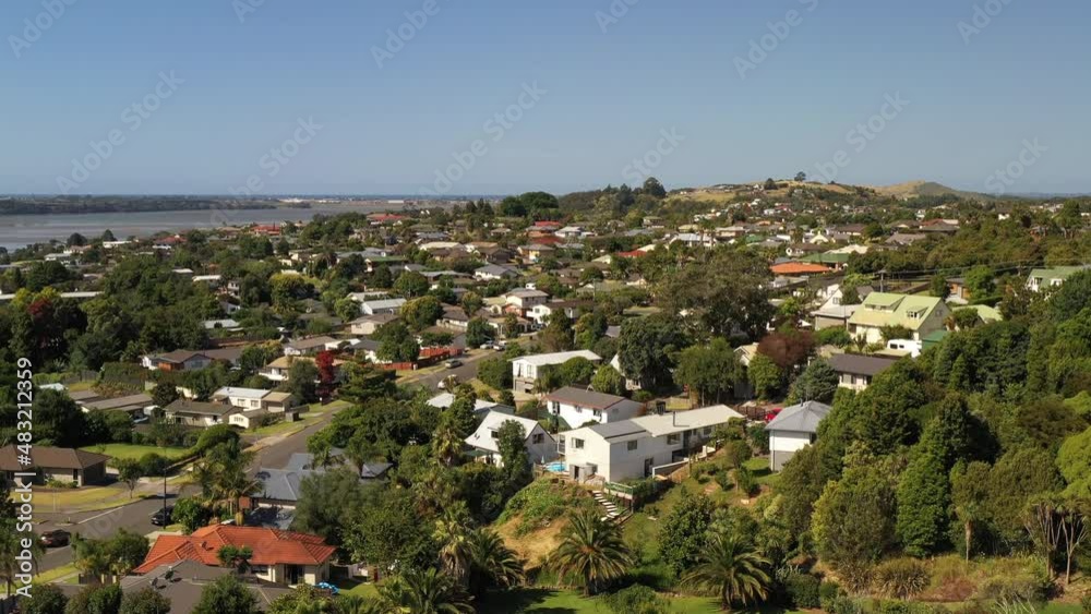 Drone shot of an unrecognizable modern suburb somewhere in the new world. Sunny summer. Sea in distance.. Tauranga, New Zealand Drone shot of an unrecognizable modern suburb somewhere in the new world. Sunny summer. Sea in distance.. Tauranga, New Zealand