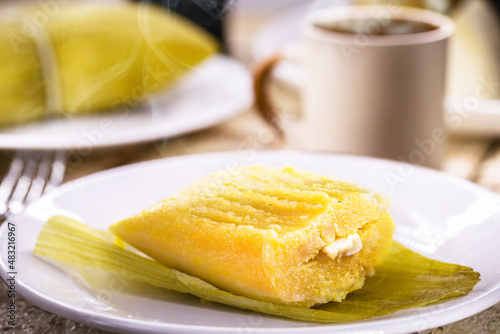 Typical Brazilian sweet pamonha made with corn and stuffed with cheese, served hot. Traditional food from Minas Gerais state
