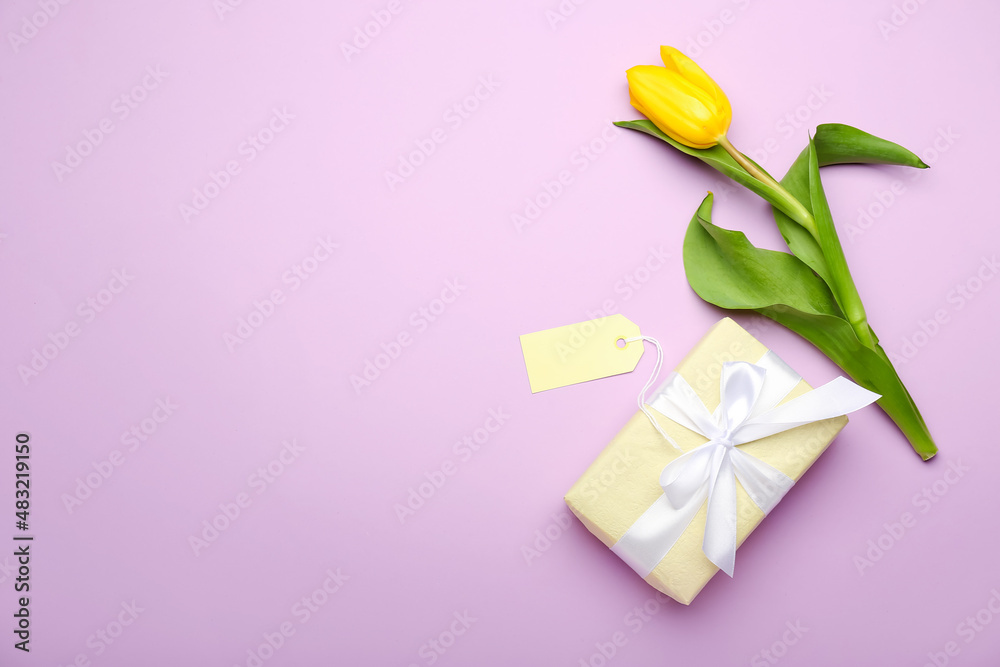 Composition with gift box, blank card and tulip for International Women's Day celebration on color background Composition with gift box, blank card and tulip for International Women's Day celebration on color background