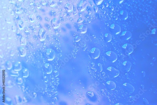 water drop background on abstract blue clear glass