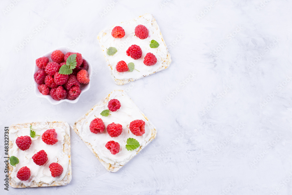 Toast with cream cheese and fresh raspberries. A delicious summer dish for breakfast.