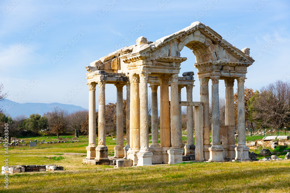 Ancient ruined construction of monumental gate of small Greek city of Aphrodisias in classical architectural form of tetrapylon located in modern Aydin Province, Turkey