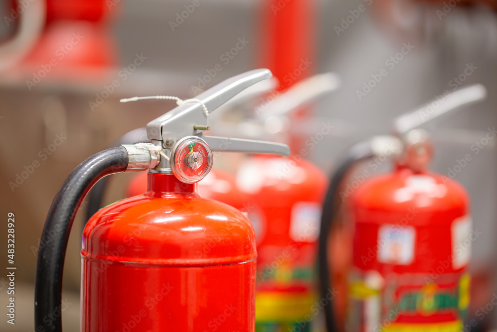 The red fire extinguisher is in the building for fire prevention and safety.