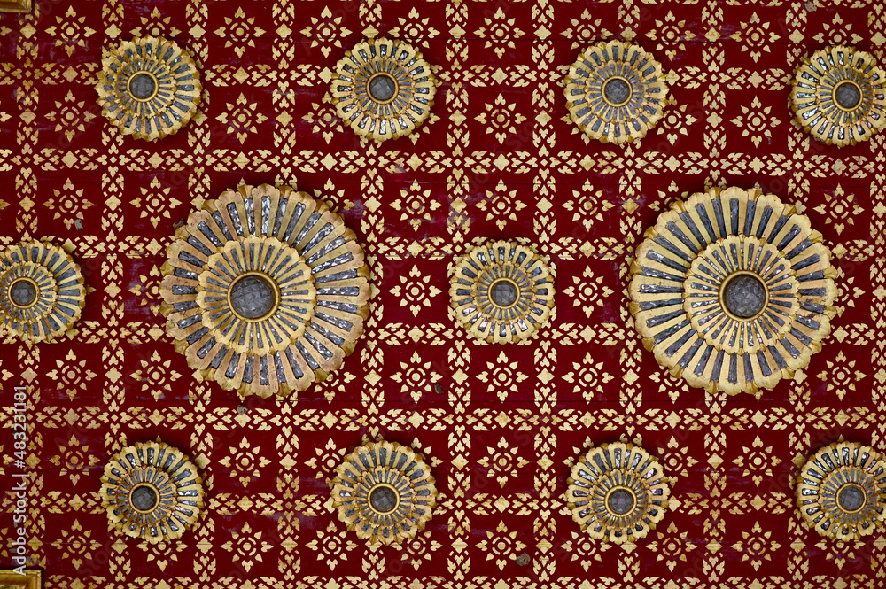 Golden Pattern of Thai art on Red wall in Thai Temple at Thailand. It is suit for use as Background