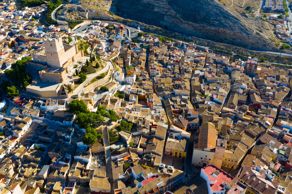 Scenic view from drone of historic center of Spanish city of Villena overlooking fortified Castle de Atalaya, Alicante..