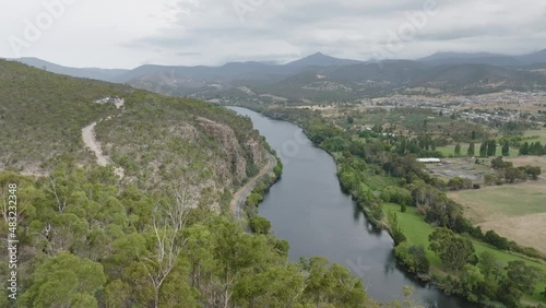 High angle aerial 4k drone footage of River Derwent, one of the major rivers on the island of Tasmania, Australia. Town of New Norfolk on the right, 30 kilometres from Tasmanias Capital City Hobart. photo