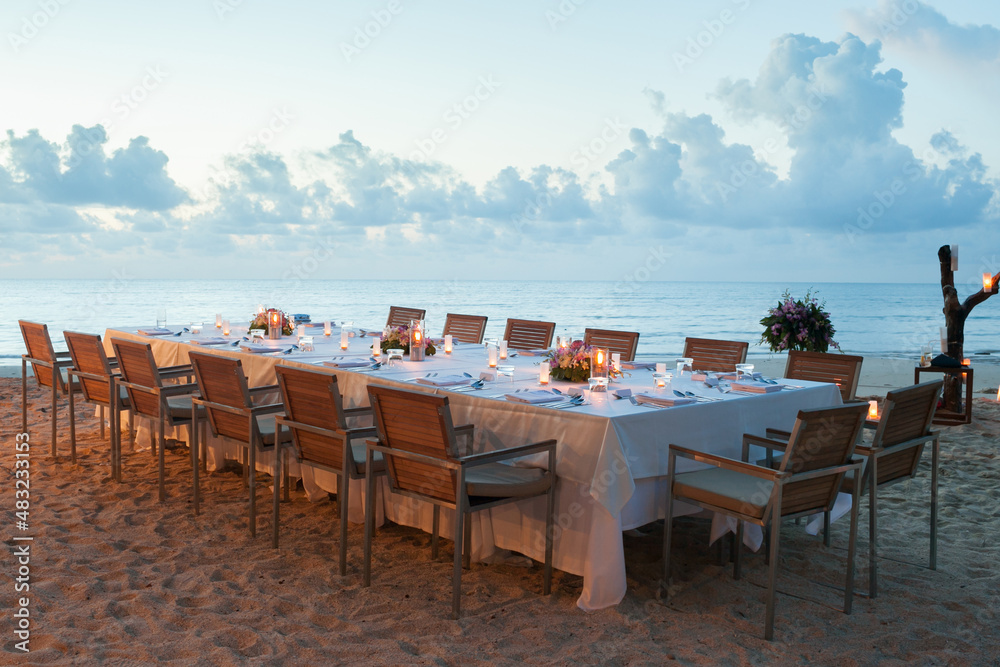 long dinner table on the beach.