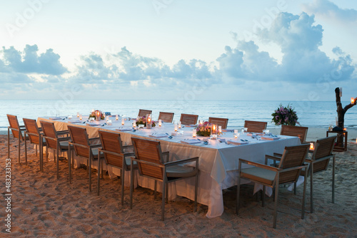 long dinner table on the beach.